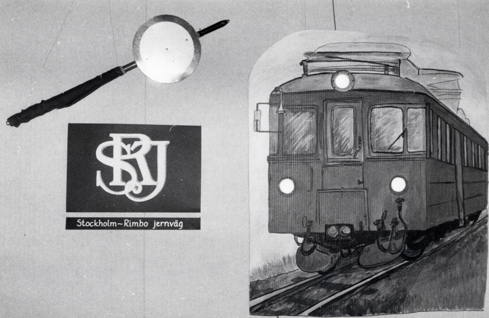 Utställningen Roslagsbanan i vallentunabygden 1885-1985 visades i Vallentunasalen 26 november 1985-7 januari 1986. Fullstända uppgifter om utställningen se 040 05 06: 001. På bilden syns en Stinsspade utlånad av Gustaf Åkerblom kopia av vagnemblen SRJ lånat av Föreningen Rädda Roslagsbanan Motorvagnen X7p 48 från år 1946 har förstorats från en diabild. Motorvagnen har försetts med lyktor och belysning i lyktor och strålkastare. Se: Roslagsbanan och bygden, 1985, samt andra publikationer utgivna i samband med 100-års jubiléet.