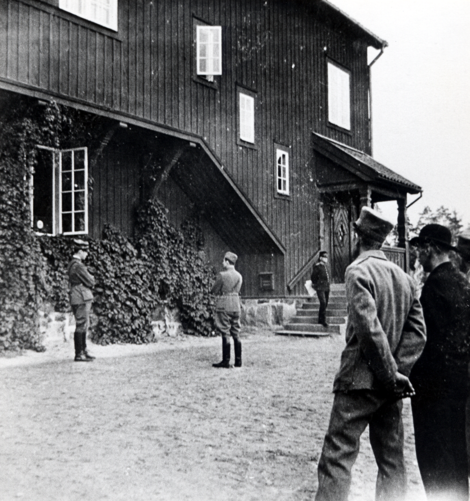 Befäl  och  manskap  lyssnar allvarliga på en  radioutsändning  vid  Hjälmsta skola .  Radiomottagaren  står i det öppna fönstret
