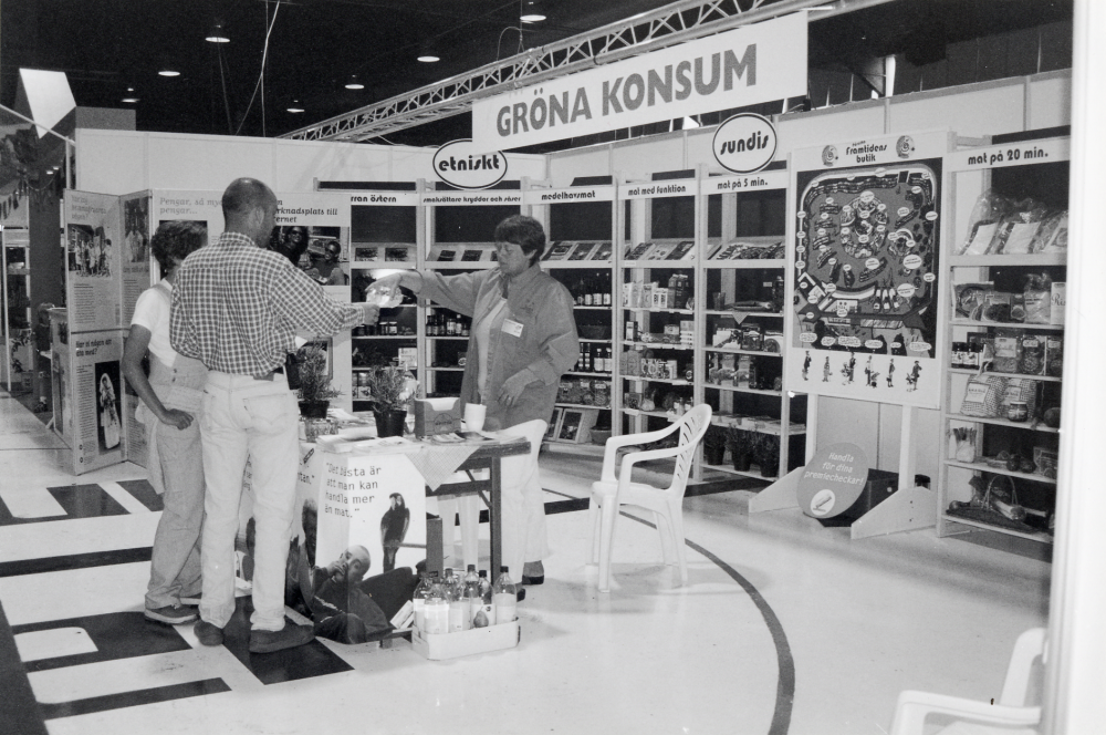 Vallentuna fack- och konsumentmässa EXPO 98. På mässan presenterades företag och kommun.  Mässan pågick i Ishallen 14 till 17 maj.  Här erbjuder Gröna Konsum provsmakning och ekologiska varor.  Lisa Stålnacke och Mikael Hillbo får ekologisk äppeljuice