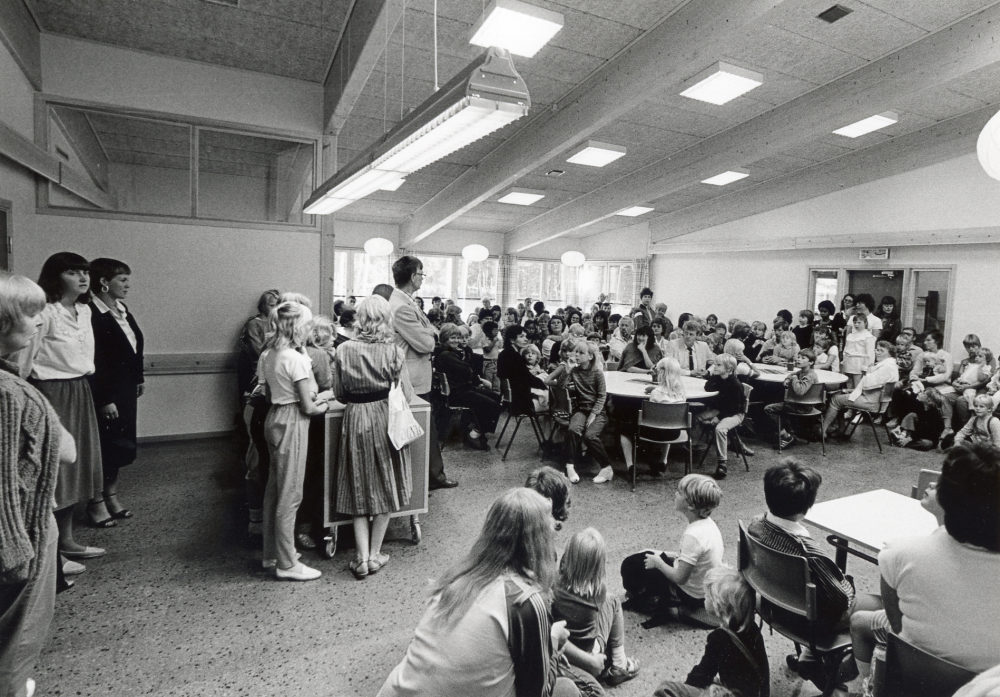 Nya Kårstaskolan vid Bergsjövägen första skoldagen höstterminen 1982 .  Skolbarnen med föräldrar och skolans personal har samlats i matsalen