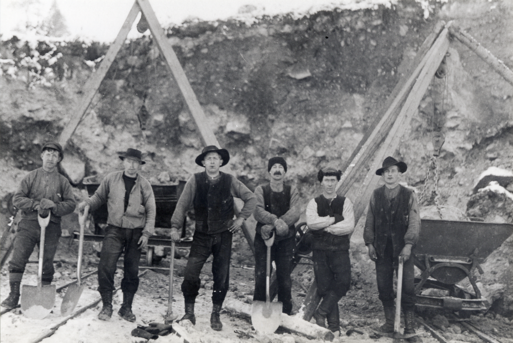 Schaktningsarbete i Össeby-Garn, förmodligen vid Forsenbergsbacken i Lilla Garn.  För att underlätta arbetet användes decauvillespår där de små järnvägsvagnarna transporterar bort den sten och det grus man gräver bort.  Arbetsplatsen kan också vara vid Stångberga.  Alla personer okända