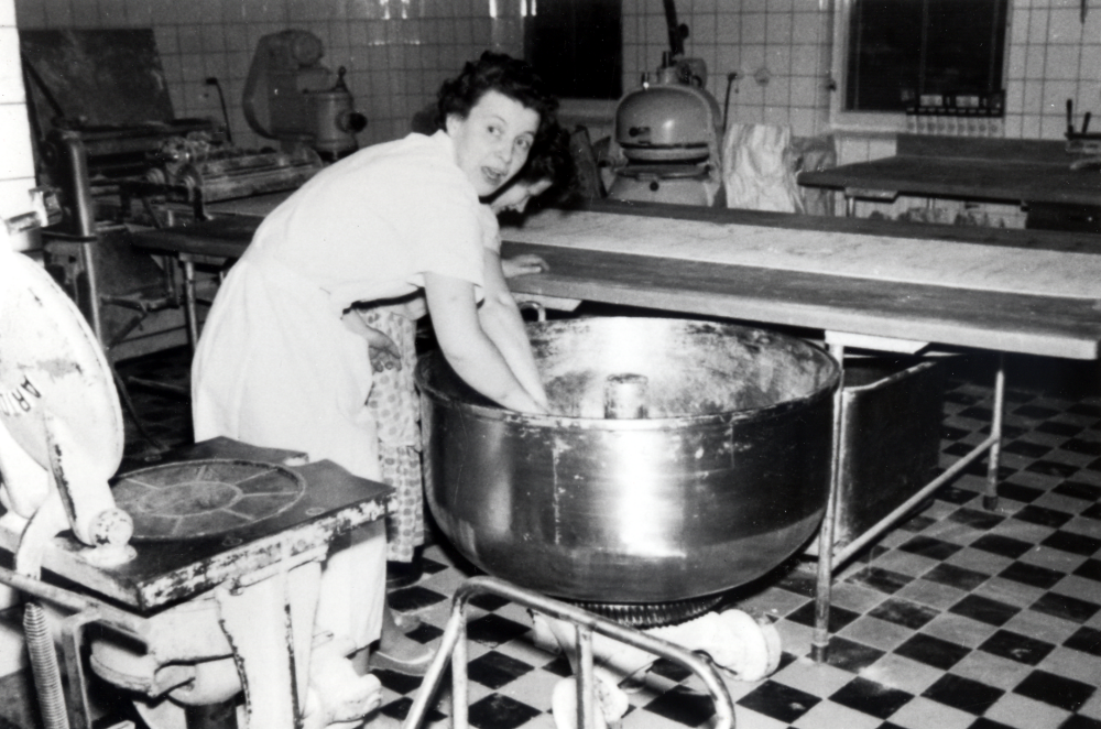 WT-bageriet stod färdigt 1955 och byggdes ut mot norr 1962.  Det byggdes och ägdes av Inga-Britt och Inge Englund, som också bodde i lägenheten ovanpå bageriet.   I bageriet bakade man från början kaffebröd, bakelser, tårtor och småkakor, som mest hade bageriet 19 anställda. Från 1962 bakade man framförallt skorpor, 8 000 runda bullar i timmen, vilka delades och blev 16 000 skorpor.  Skorporna var välkända ända till Skåne.  Stockholms landsting köpte 75 ton av skorporna varje år.  Här står Inga-Britt Englund vid en av de tre deggrytorna.  Bakom hennes står en runddrivare, en maskin som rullar småfranska.  Bredvid Inga-Britt s tår ev fru Wadlund. Bageriverksamheten lades ner vid årsskiftet 1975-76.