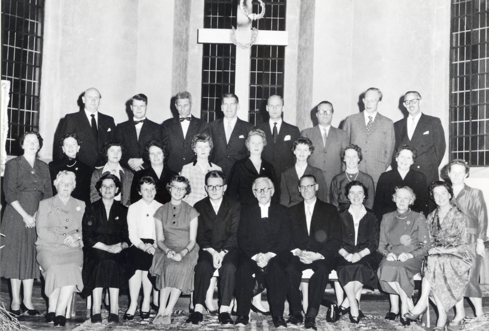 Vallentuna kyrkokör samlade i koret i Vallentuna kyrka.  I övre raden fr v står Gunnar Åhs, okänd, Martin Nilsson, Gösta Bornholm, Bertil Söderman, Erik Svenander, Åke Carlestam och Gunnar Rickberg.  Mittenraden fr v: Majken Jansson, Evy Lööv, Kerstin Andemark, Anna-Lisa Gustafsson, Agneta och Monika Lööv, Viola Wester, Else-Marie Carlegrim, Olga Johnsson och Maja Sundborg.  Sittande fr v Olga Jansson Aina Bornholm, Kristina Rosén, Catarina Vängby, Erik Mohlin, kontraktsprost Sven Vängby, Holger och Elna Hovmark, Ragnhild Vängby samt Dagny Catoni