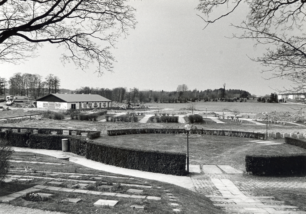 Vallentuna kyrkogård utökas mot väster.  T v syns Prästgårdens ladugård, t h bostadsområdet Sörgården.  I bildens mitt skymtar Väsby kvarn