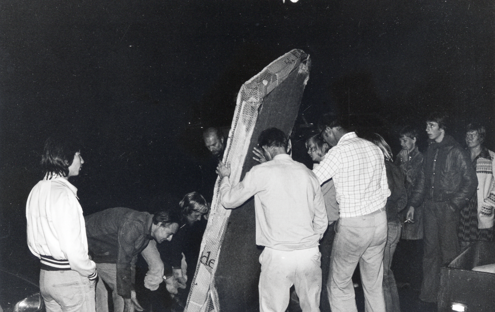 Ny runsten vid Vallentuna järnvägsstation efter indragning av busslinje 601 mellan Vallentuna och Jarlabankes bro. Vallentunas nyaste runsten restes natten mellan den 11 och 12 september 1975. Initiativtagare till stenen var Bo G Eriksson och Anthony Eyre. Roberto Dünkelberg översatte texten till runor. Texten på stenen lyder: Resande reste rasande stenen, snöda skrymtare snodde knarr folkvalde vise nu vanligt vett  Vallentuna väntar på bussen Gud hjälpe SL  Ante högg.  Vid resningen syns böjda  vid den nya runsten fr v Anthony Eyre och Roberto Dünkelberg.  Vid stenens baksida Bo G Eriksson, okänd och Gunnar Eriksson.  Längst t h Gunilla Eriksson.