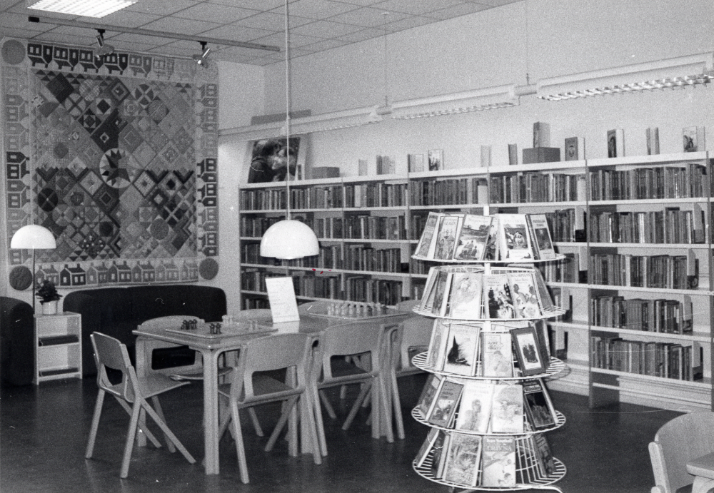 Barnavdelningen i  Vallentuna bibliotek  där ett lapptäcke gjort av  Magdalena Karlsson  hänger på väggen