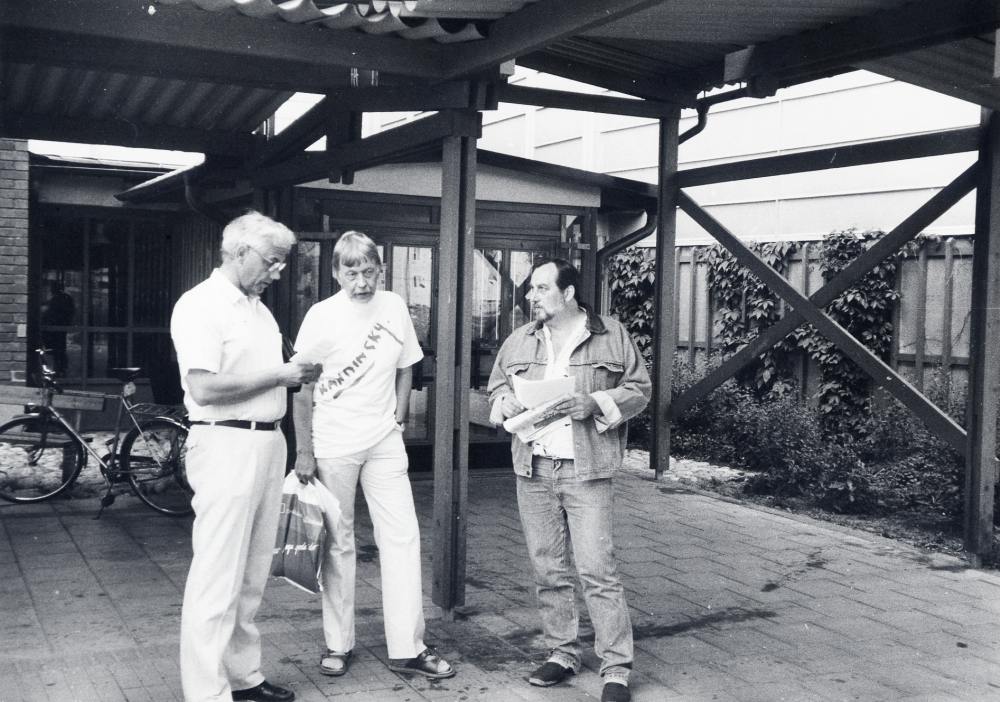 Medlemmar i KRO, Konstnärernas riksorganisation, Roberto Dünkelberg och Donald Karlsson, demonstrerar mot nedskärningar i konstanslaget utanför Vallentuna gymnasium, där Vallentuna kommunfullmäktige sammanträder 28 maj 1992.  Mannen t v är Lennart Ström