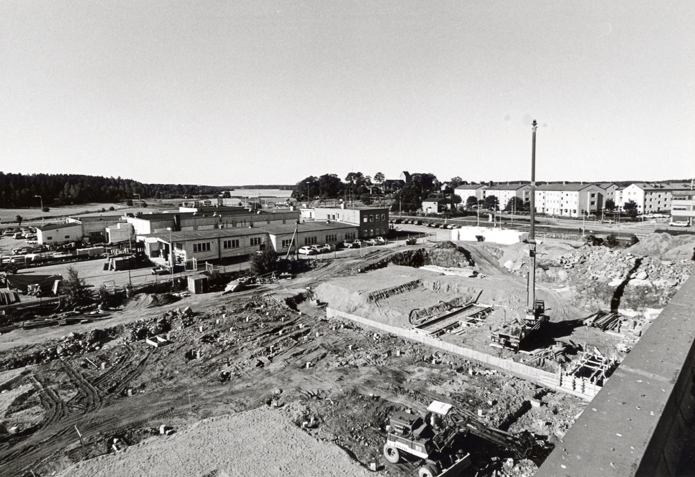 Tellus Maskins gamla fabrikslokaler byggs om till Vallentuna gymnasium med en nybyggnad för Vallentuna teater och Vallentuna sporthall t h om den gamla byggnaden. Här har grävningsarbetena påbörjats.  K S Karlssons smidesverkstad har rivits